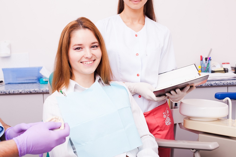 woman at a dentist taking dental checkup treatment