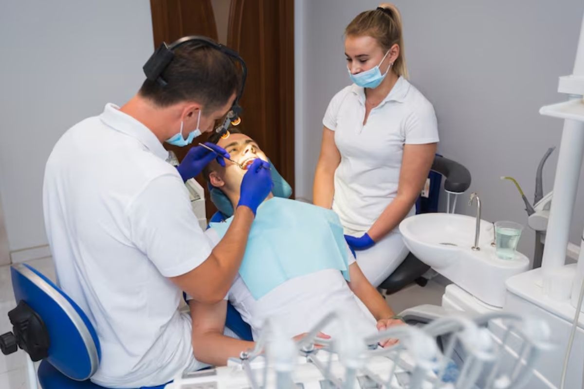 dentist performing a routine dental checkup and oral examination for preventive dental care.