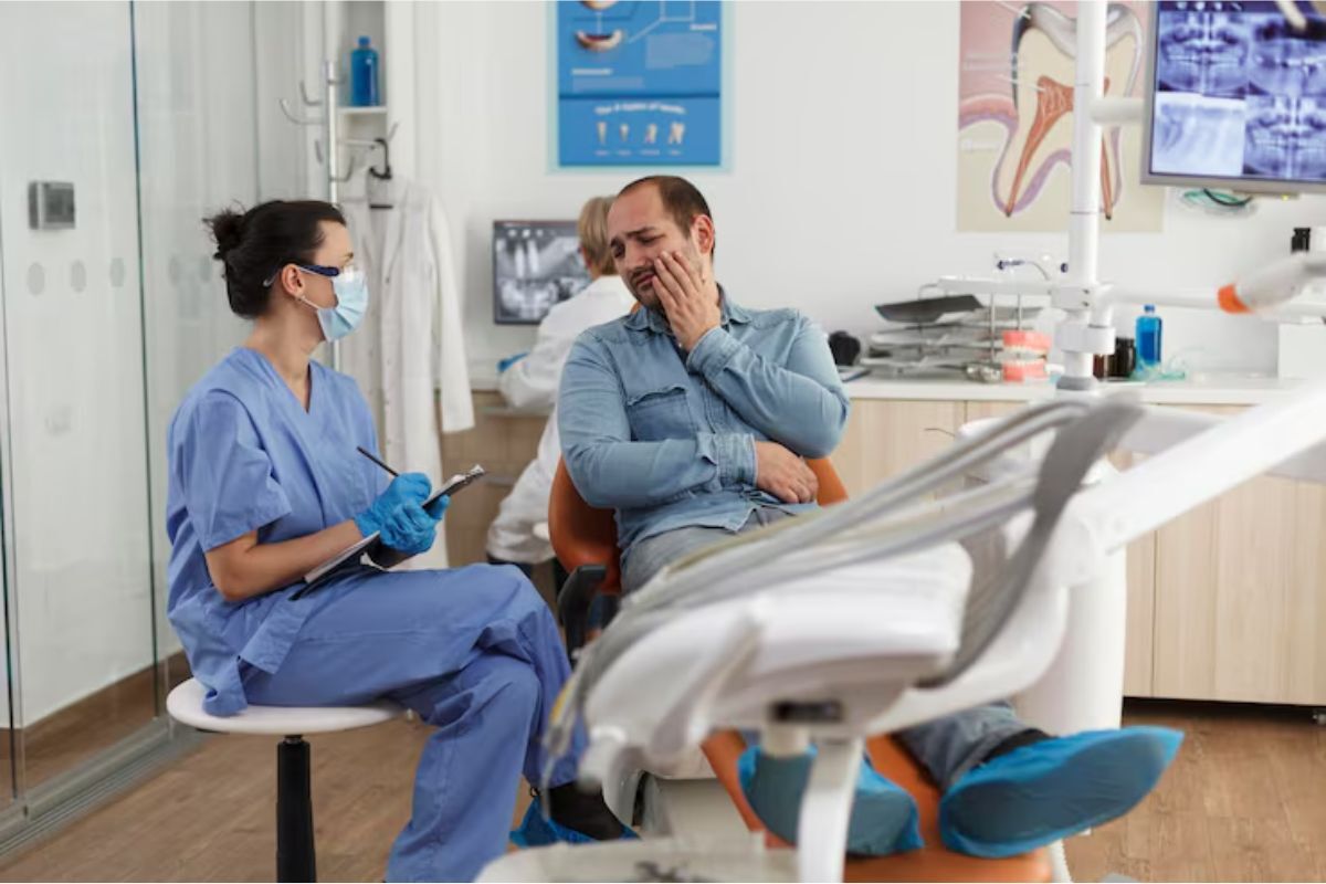 patient consulting a dentist for emergency dental care due to severe tooth pain.